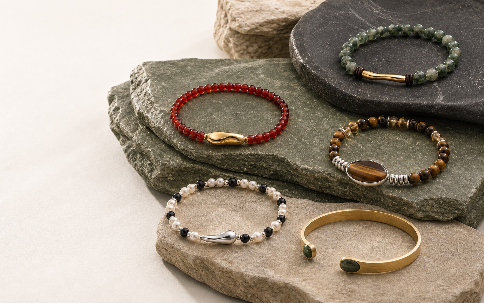 Five ONEVIDO bracelets arranged on natural stone
